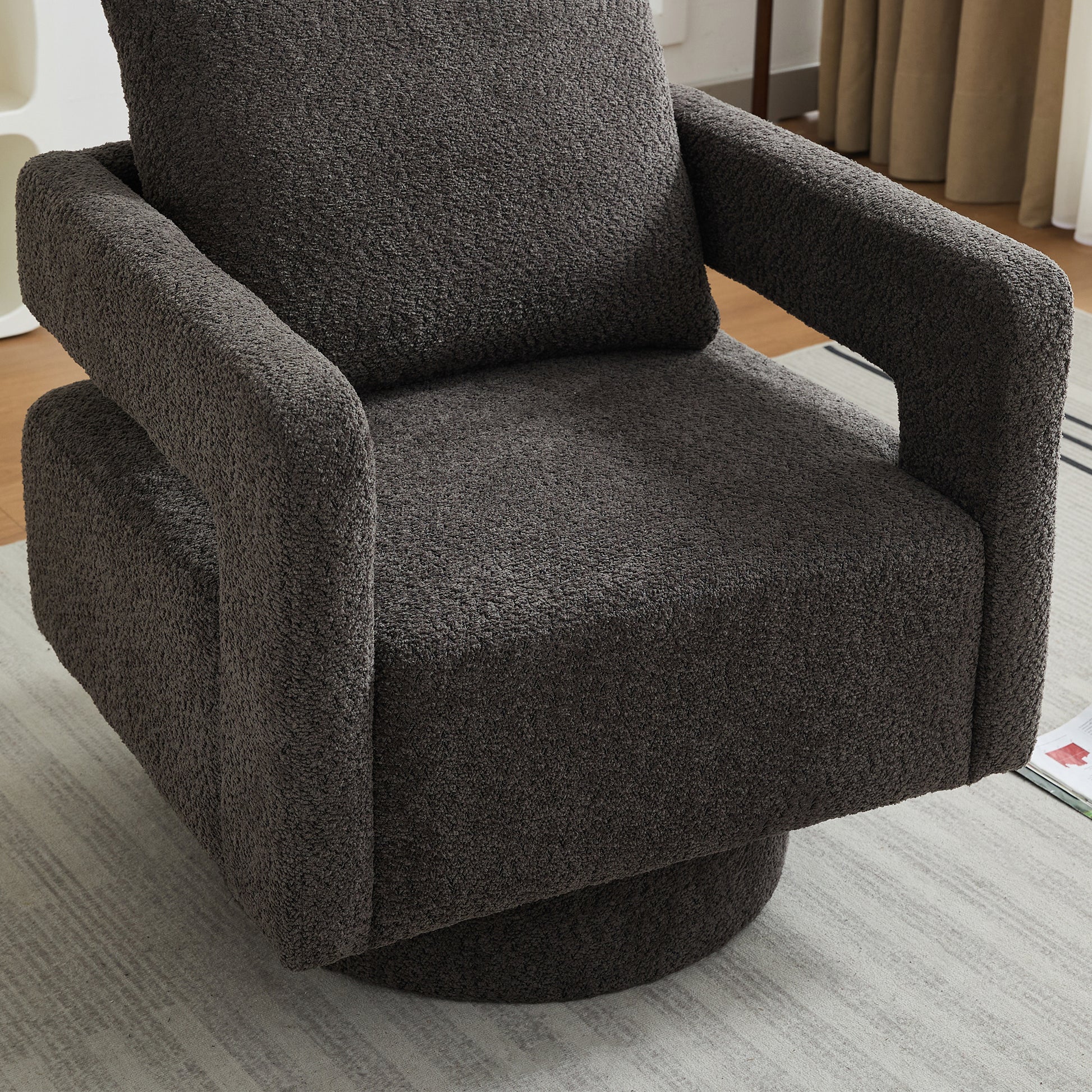 Cozy dark grey boucle swivel chair with plush cushions for modern living spaces