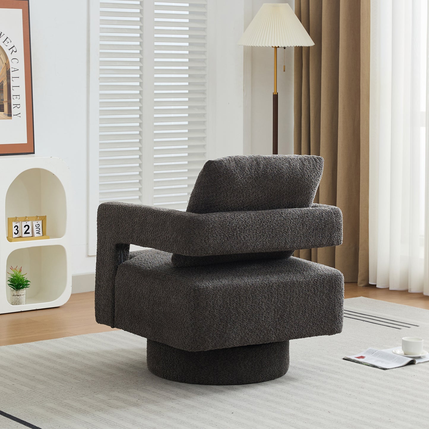 Charcoal gray boucl swivel armchair with a unique modern silhouette perfect for living room seating