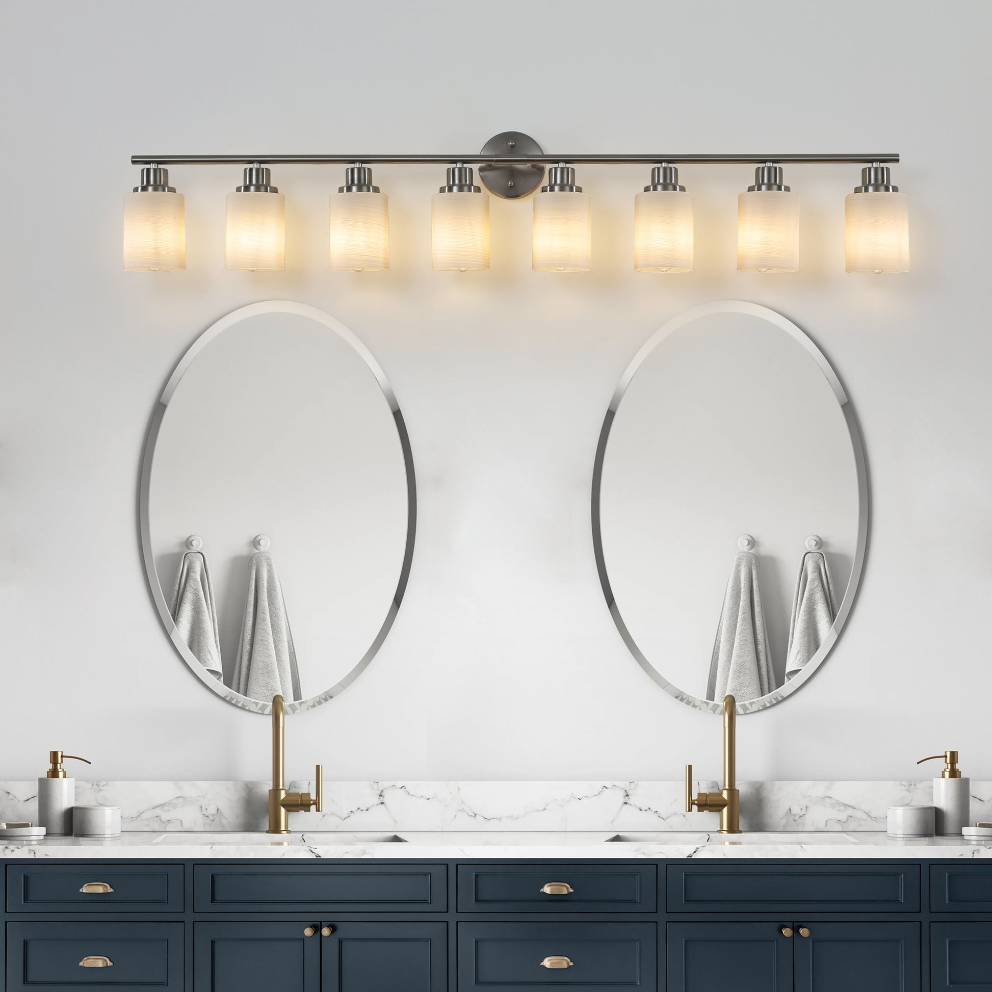 Modern brushed nickel light vanity light with frosted glass shades illuminating a bathroom setting