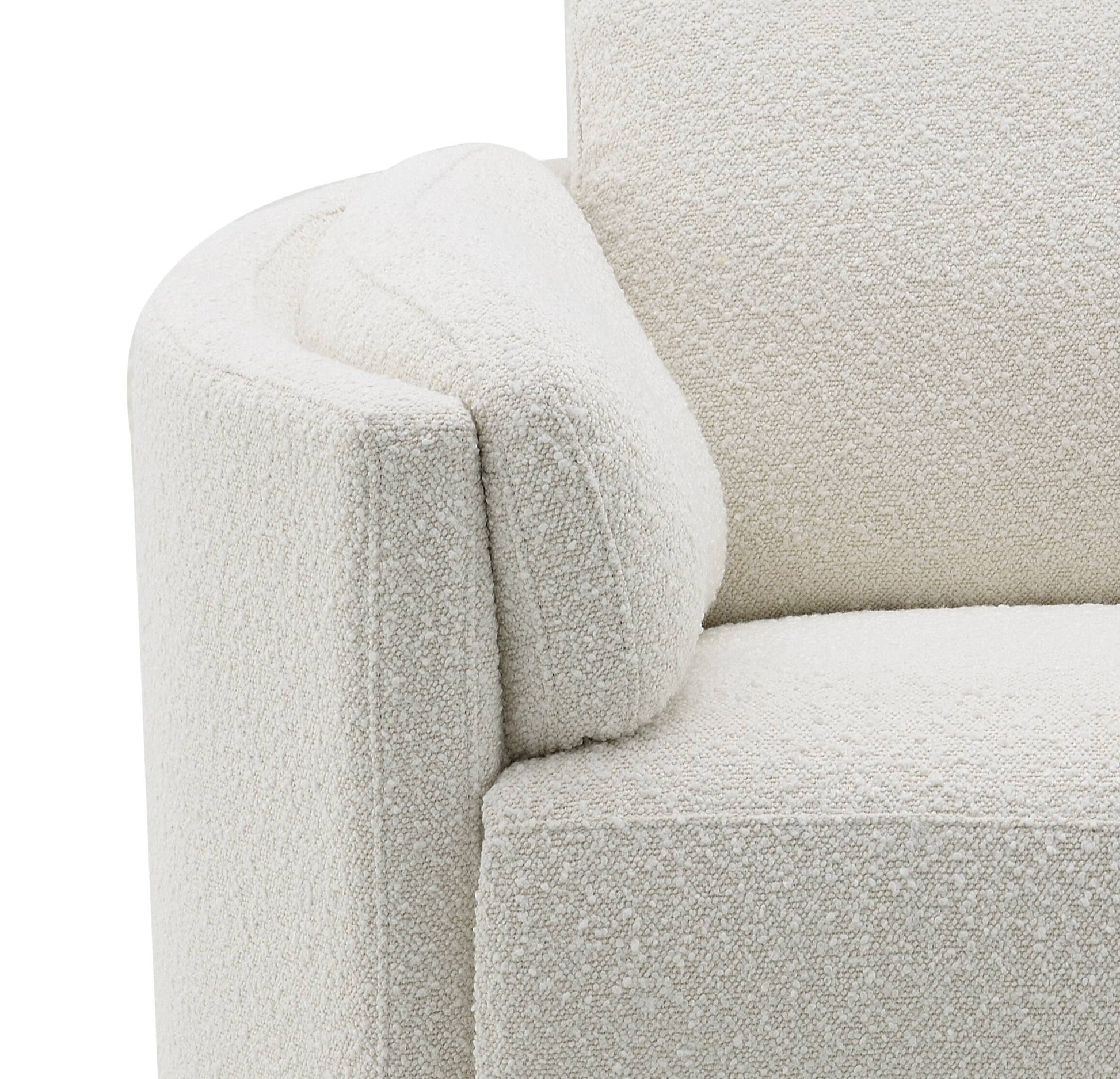 Closeup of a textured cream boucle sofa armrest highlighting the fabrics tactile quality for comfort