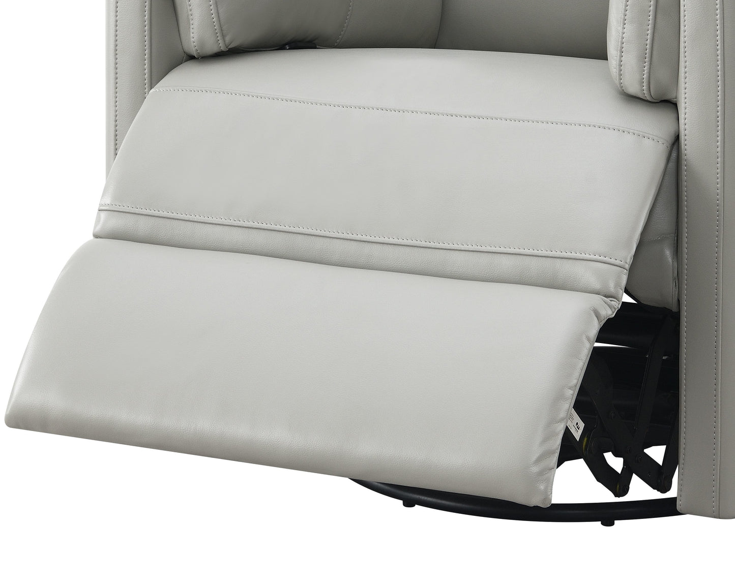 Closeup of a light gray leather recliner with padded footrest extended showing stitching detail