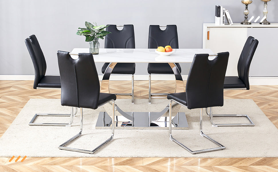 Modern black faux leather dining chairs with chrome legs around a white rectangular table