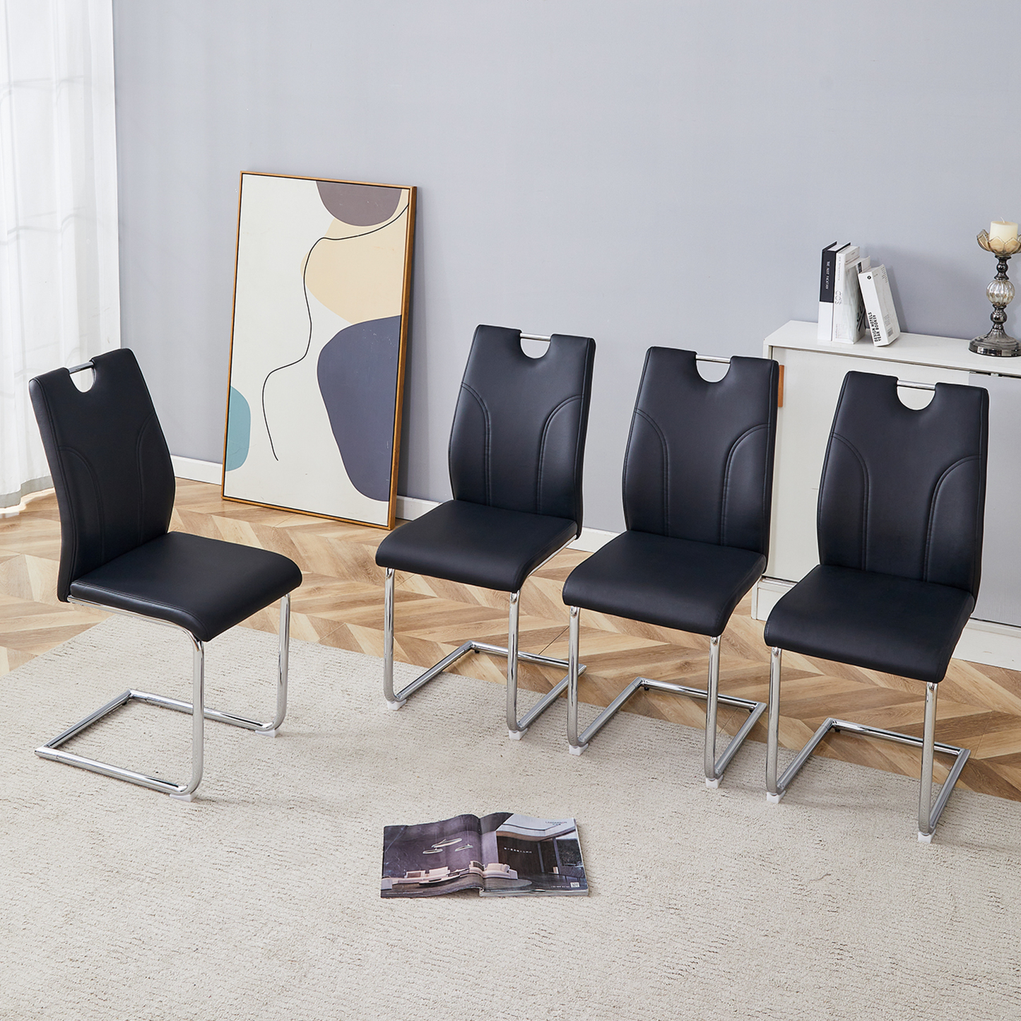 Set of  black faux leather dining chairs with chrome sled legs for modern kitchens