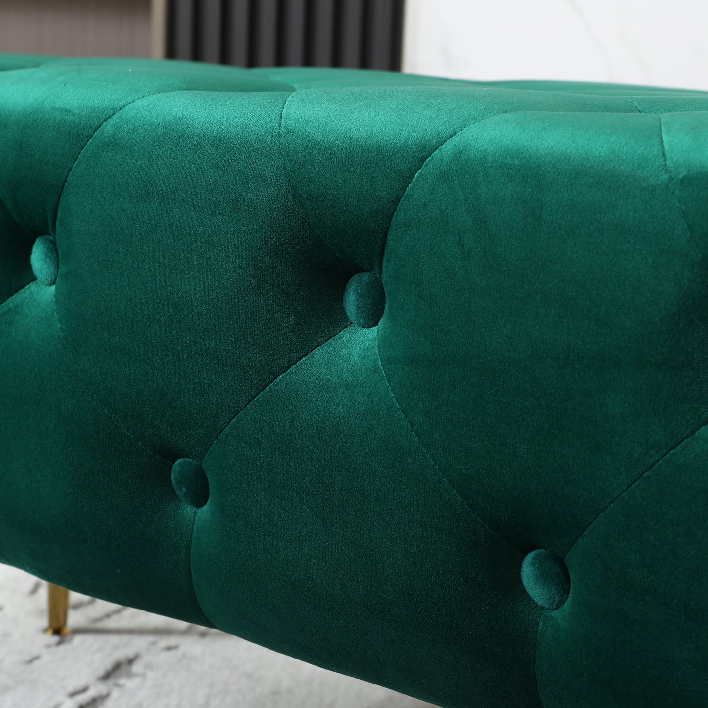 Deep emerald green velvet tufted bench with gold legs