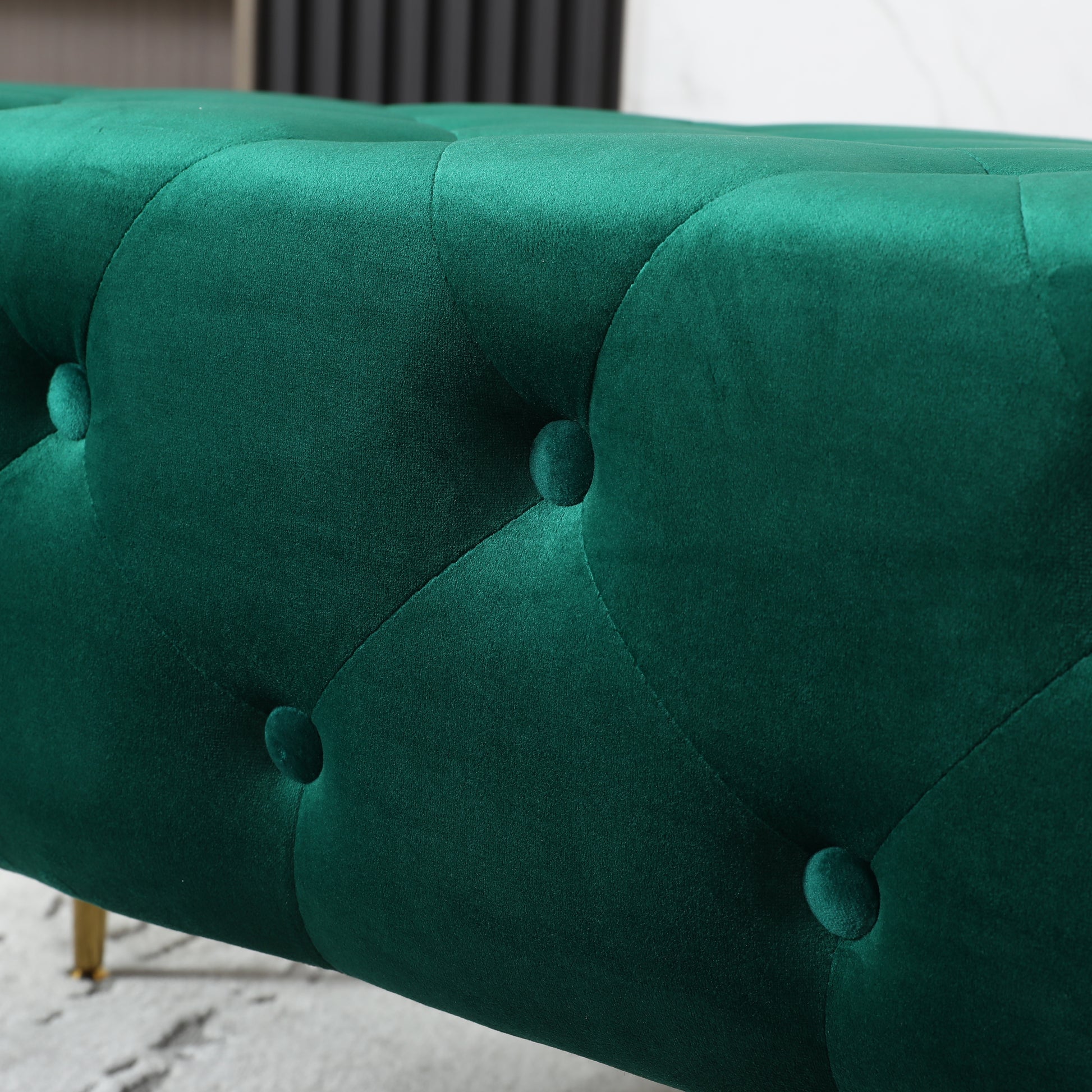 Deep emerald green velvet tufted bench with gold legs