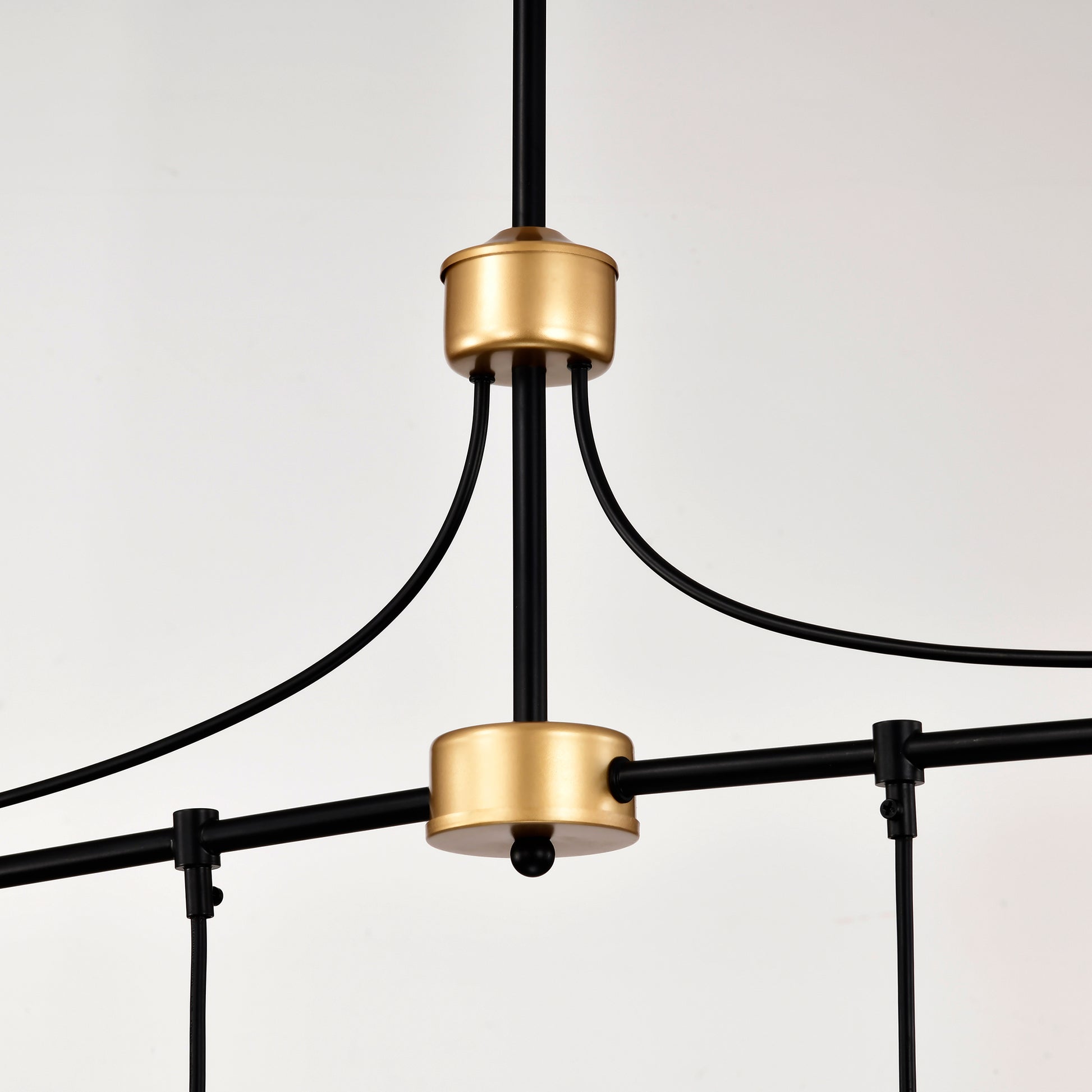 Closeup of a modern black chandelier with gold accents and clean lines