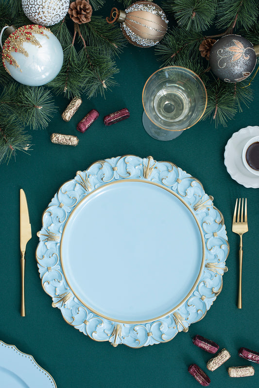 Light blue charger plate with ornate gold trim and scalloped edges for festive table settings