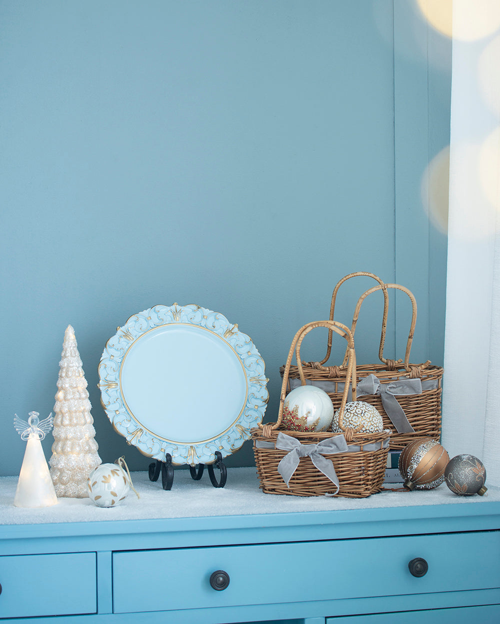 Glittering white Christmas tree with warm lights an angelic figure and decorative ornaments