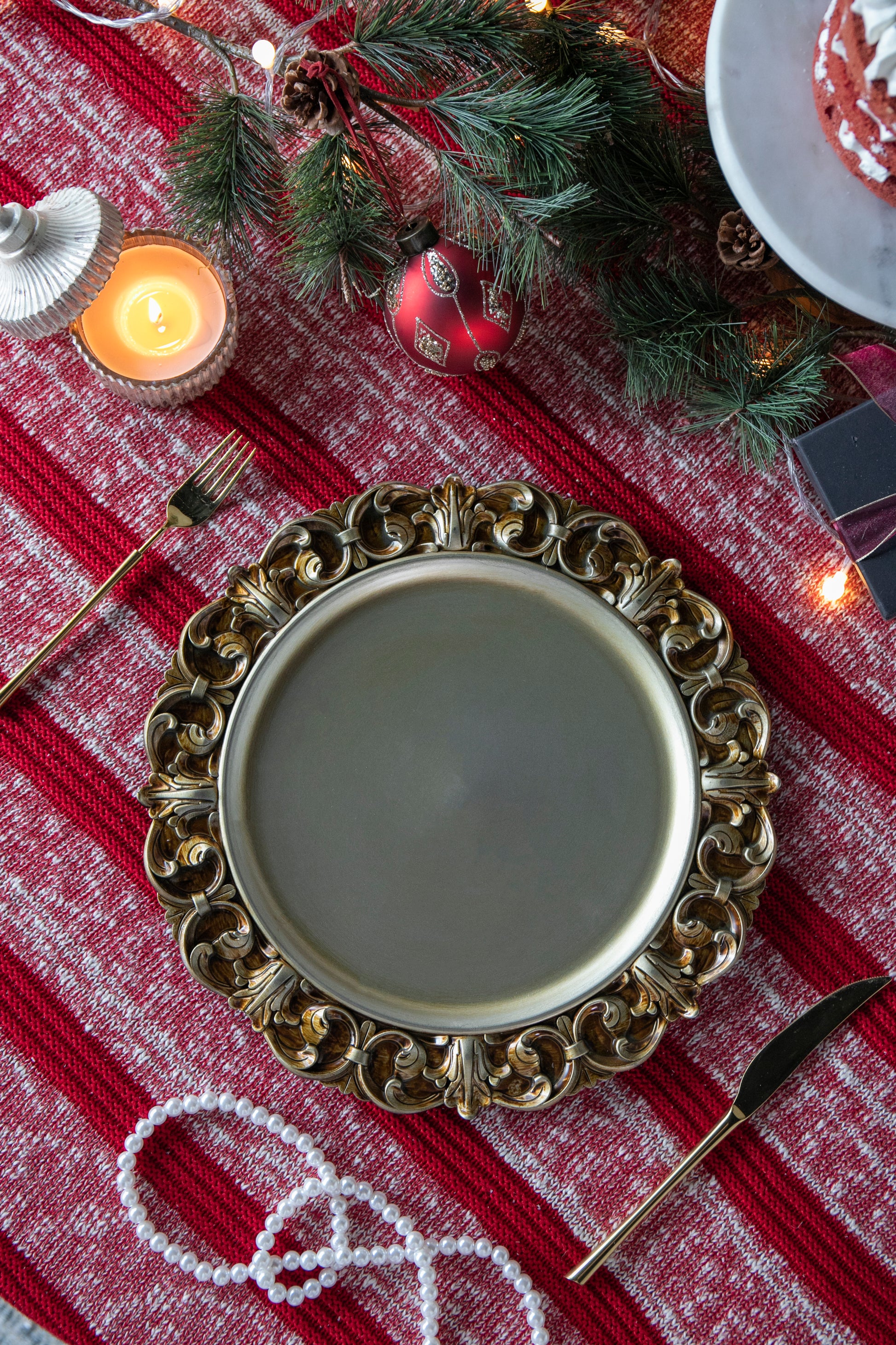 Ornate gold charger plate with intricate scrolling design perfect for elegant dinner parties