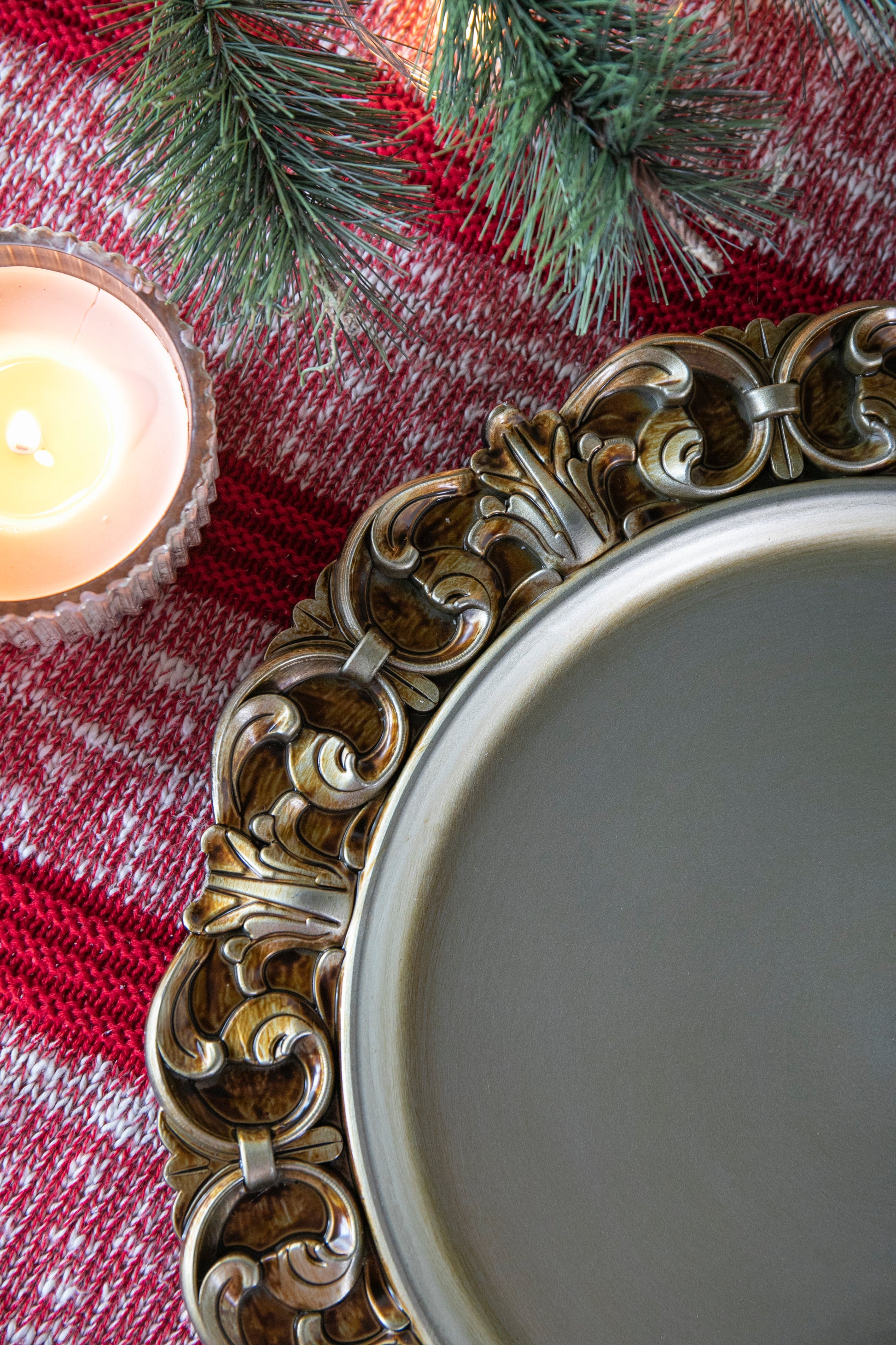 Antique gold charger plate with ornate scrollwork for festive table settings