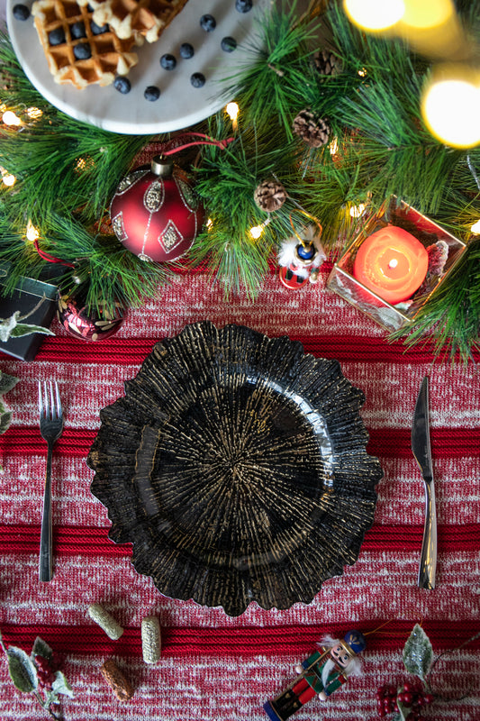 Black textured charger plate with gold accents for elegant dining settings