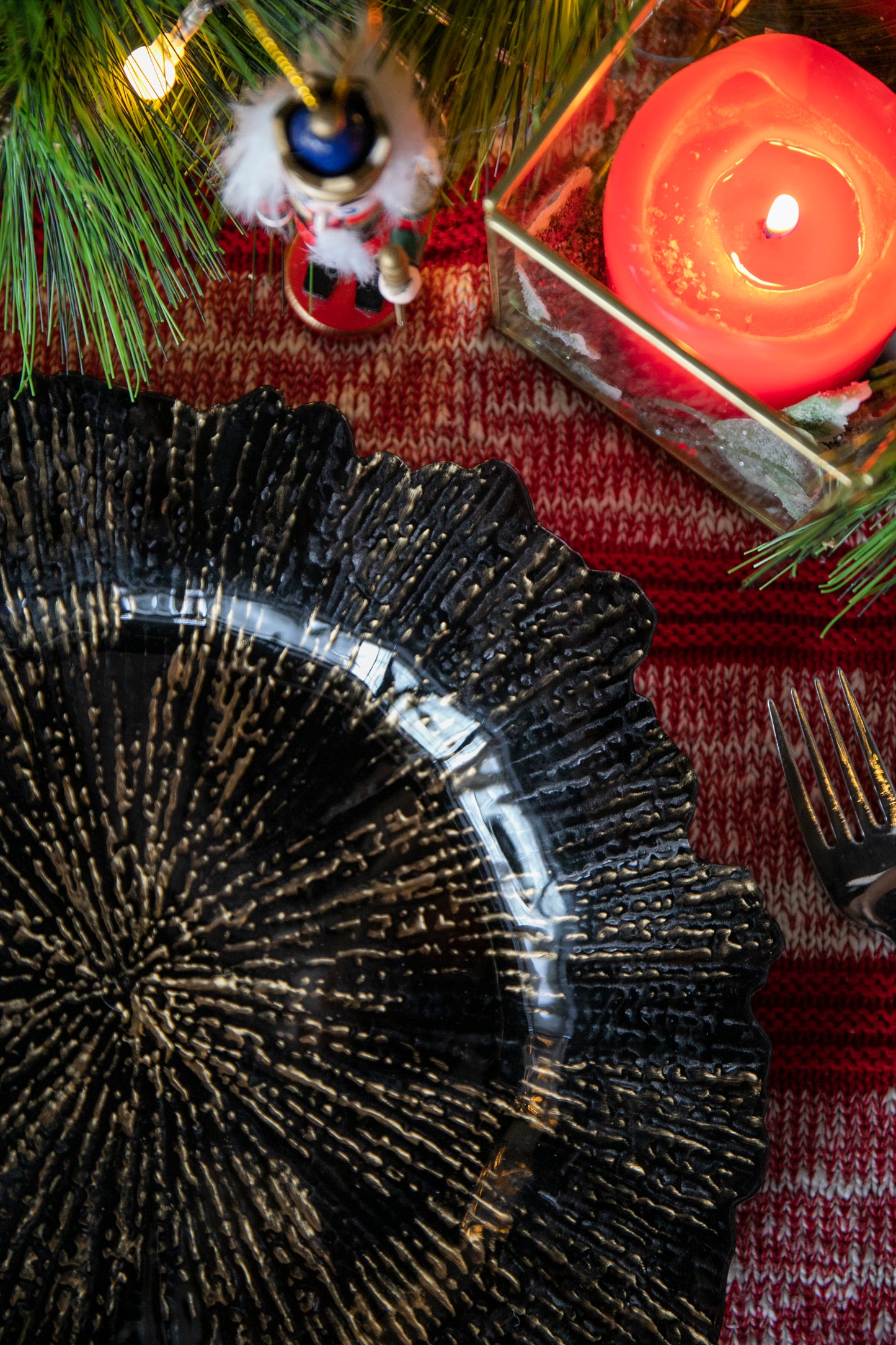Textured black charger plate with metallic gold accents ideal for holiday dining settings