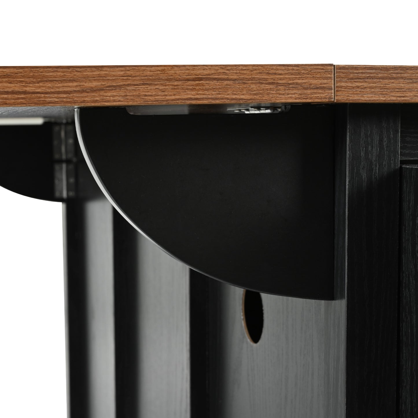 Closeup of black cabinet panel with natural wood grain top surface