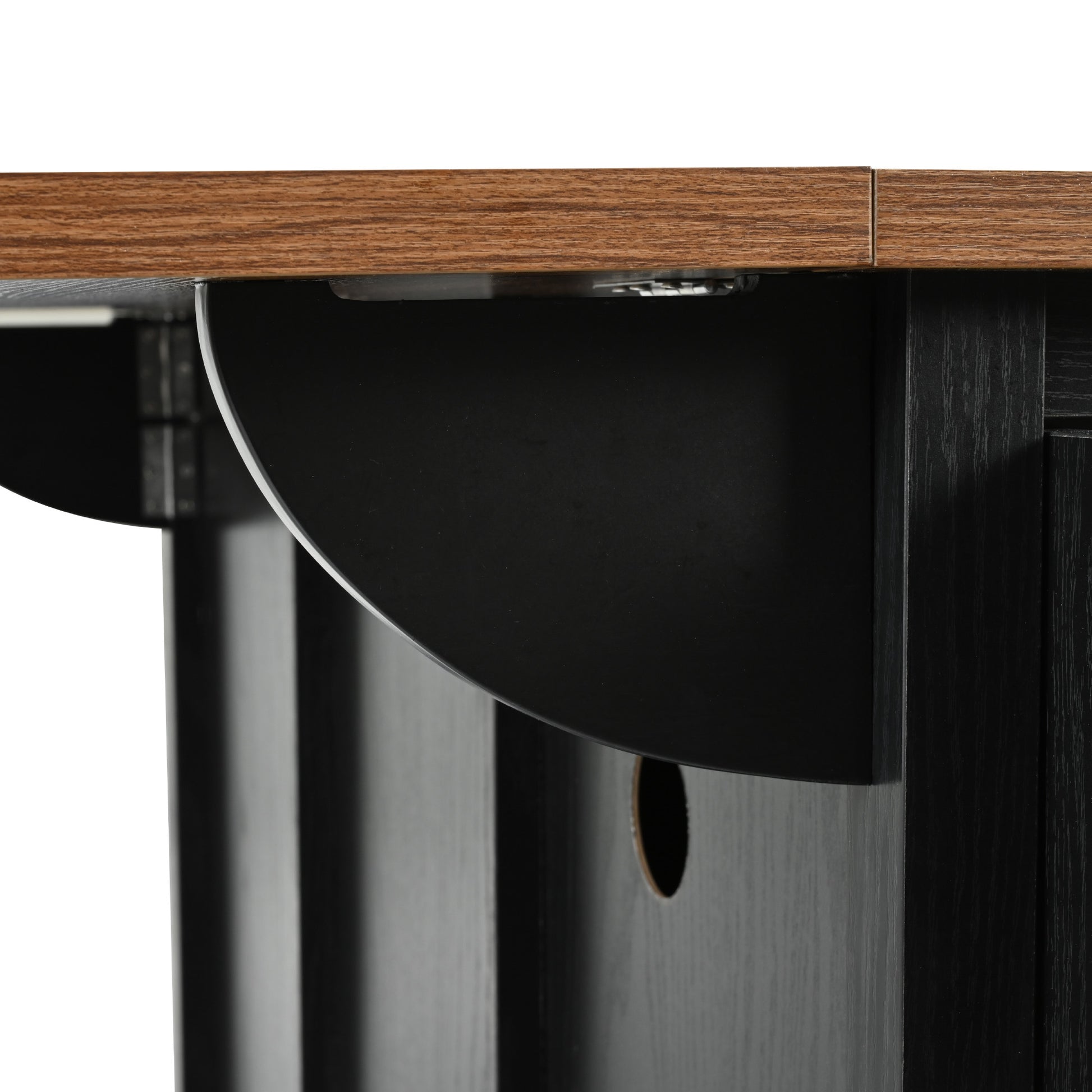 Closeup of black cabinet panel with natural wood grain top surface