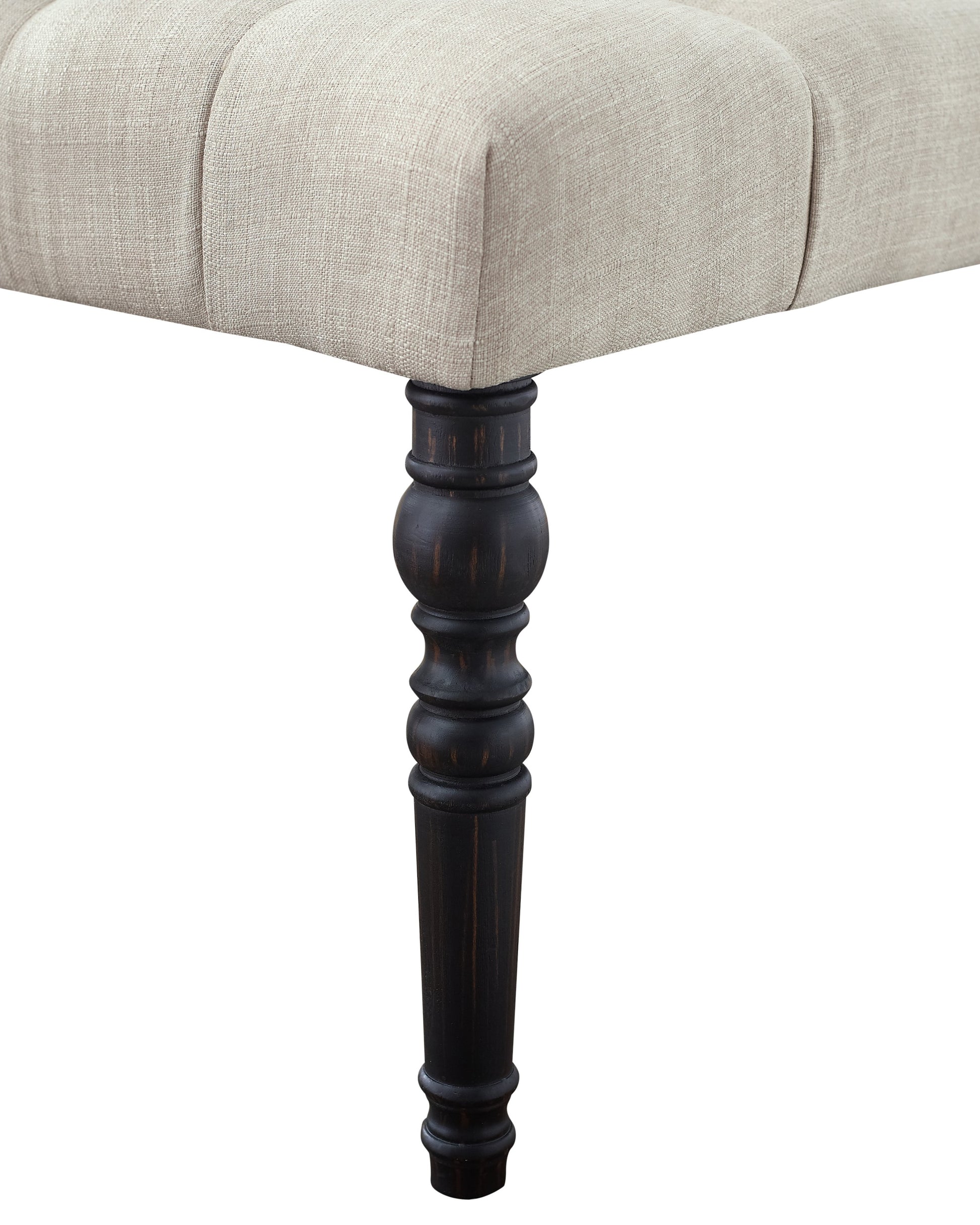 Tufted linen ottoman with dark turned wood legs