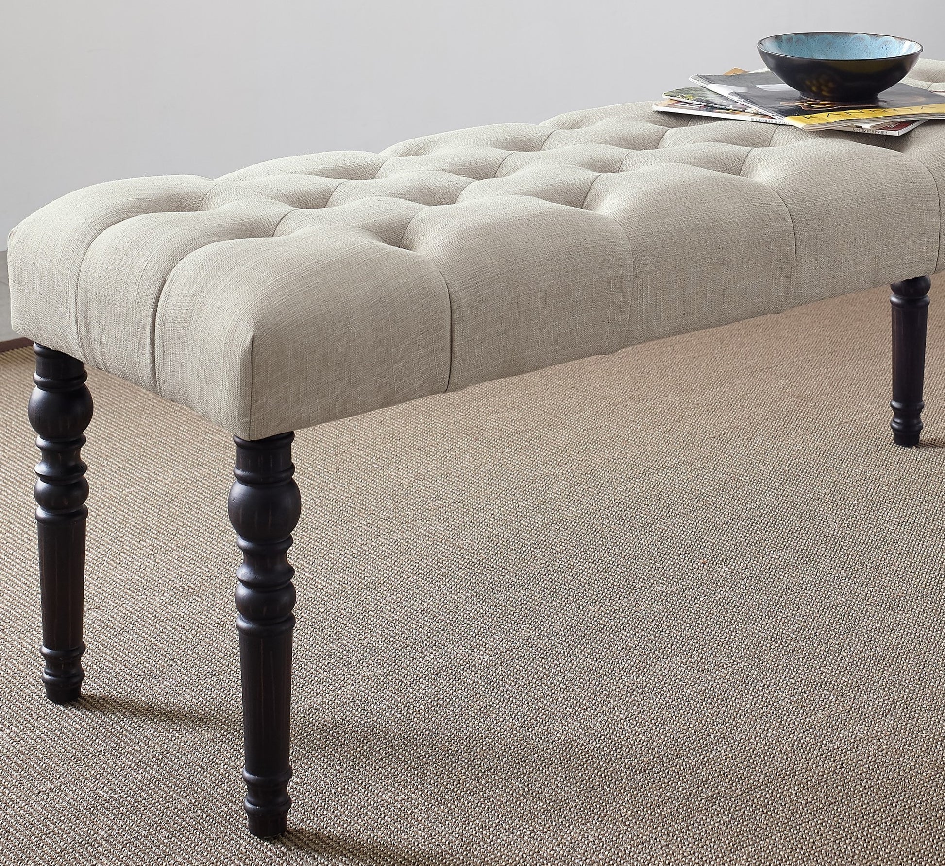 Tufted linen bench in beige with dark wood turned legs perfect for entryway seating