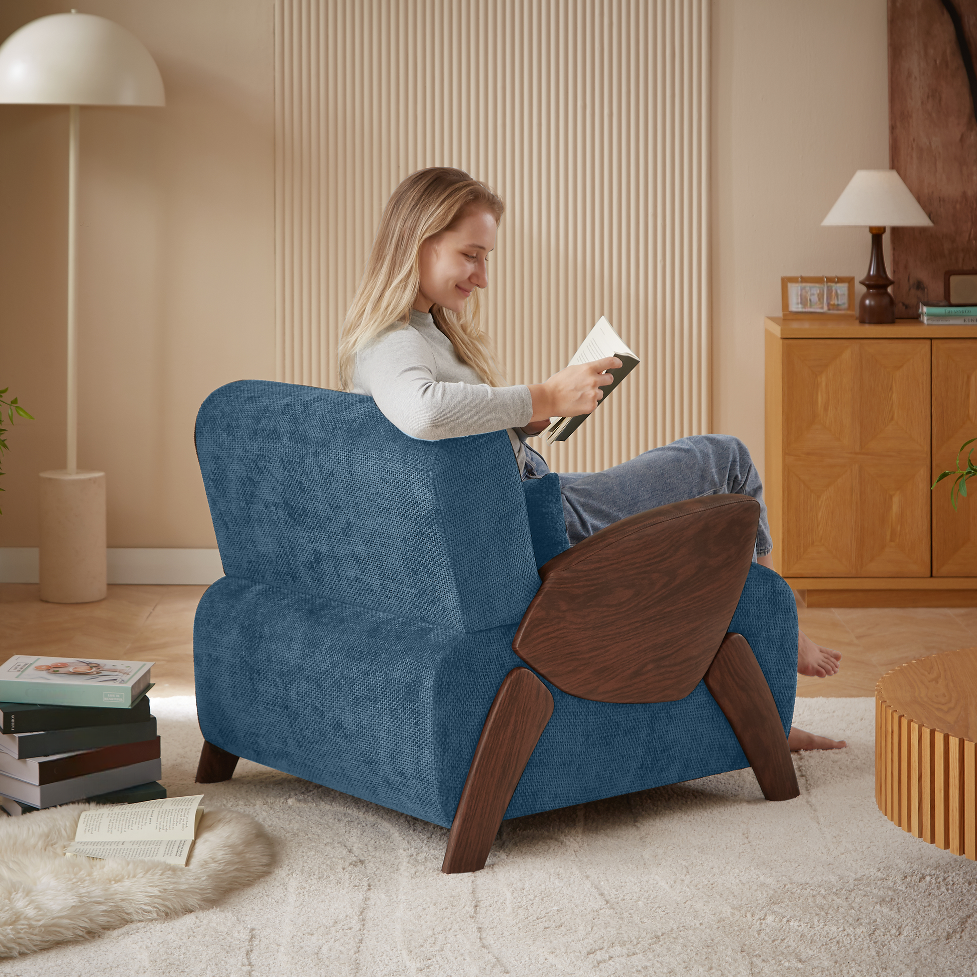 Comfortable blue fabric armchair with midcentury modern wooden accents perfect for reading