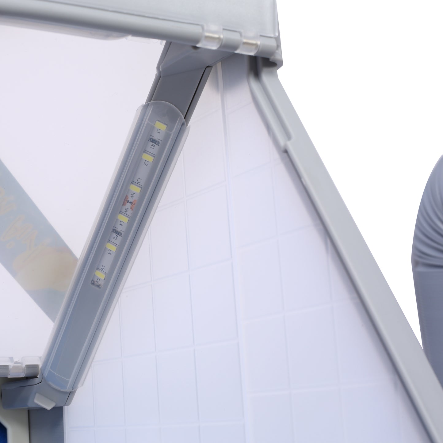 Closeup of an LED light strip with visible components and V rating