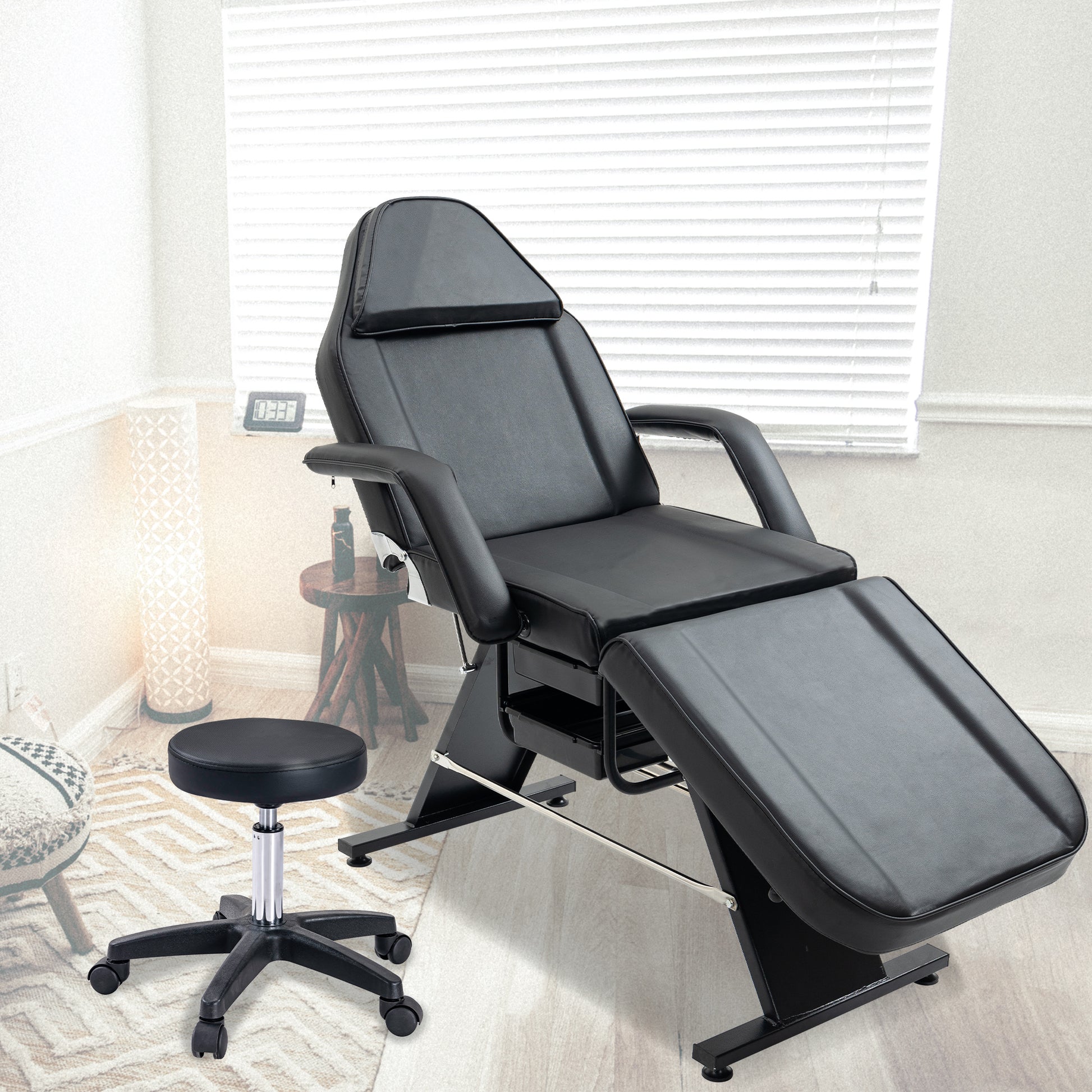 Adjustable black massage table with a comfortable headrest and armrests