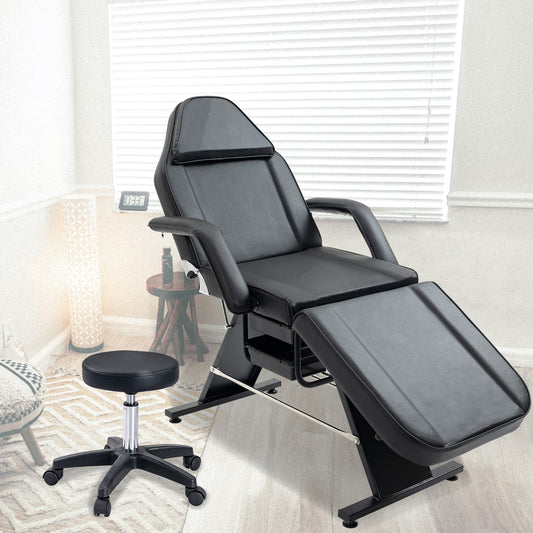 Adjustable black massage table with a comfortable headrest and armrests