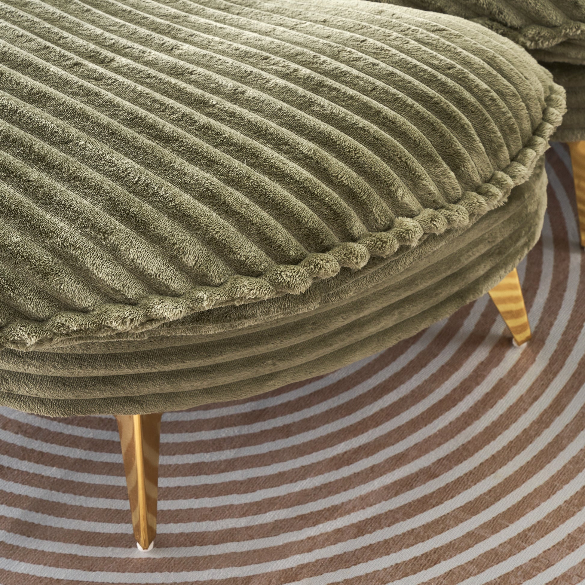 Sage green corduroy ottoman with plush textured fabric and gold tapered legs