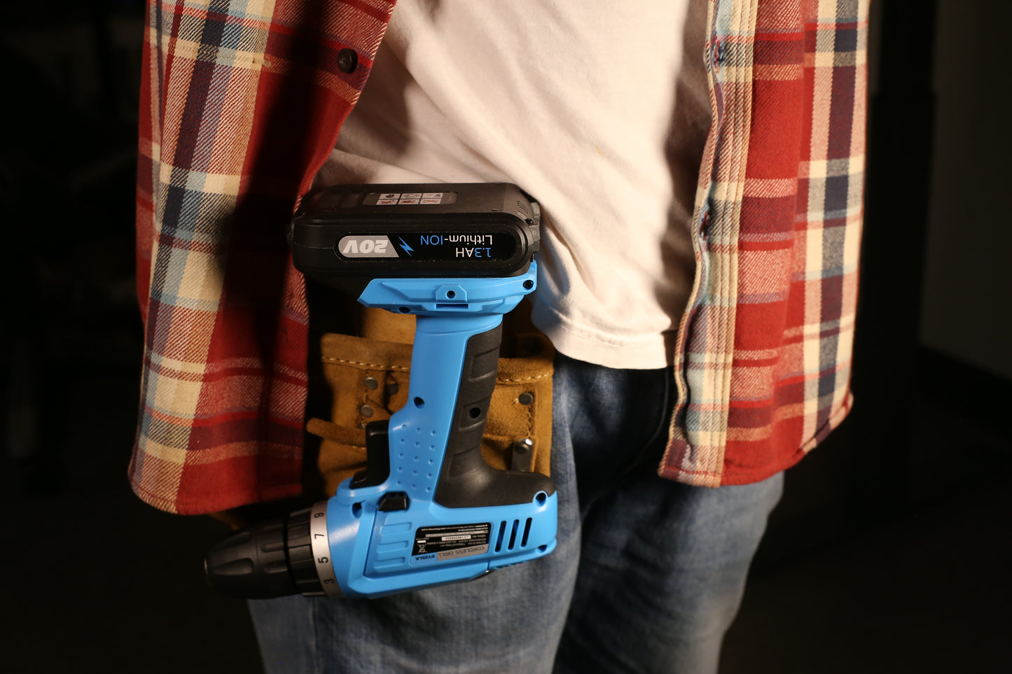 Blue and black V cordless drill with lithiumion battery attached to a tool belt
