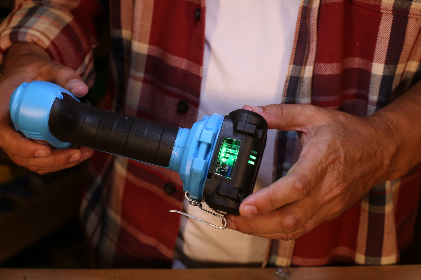 Bright blue and black cordless drill with illuminated battery indicator