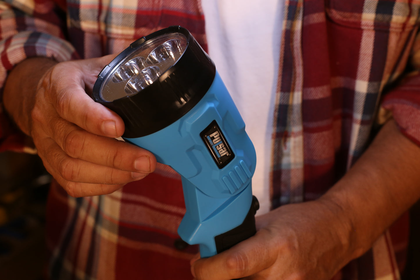 Blue Pulsar flashlight with  LED bulbs held by hands
