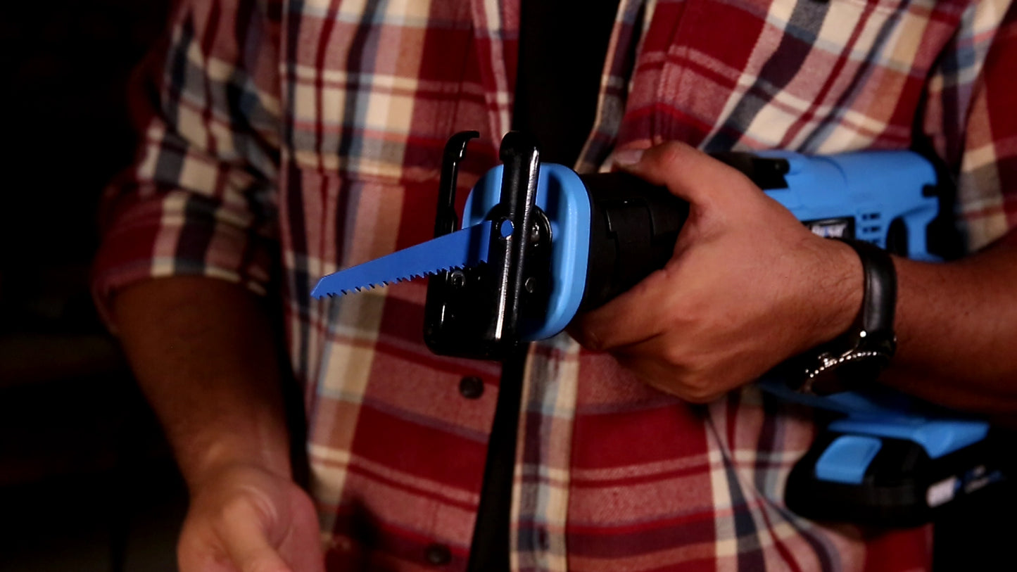 Blue reciprocating saw with blue blade held by person in plaid shirt