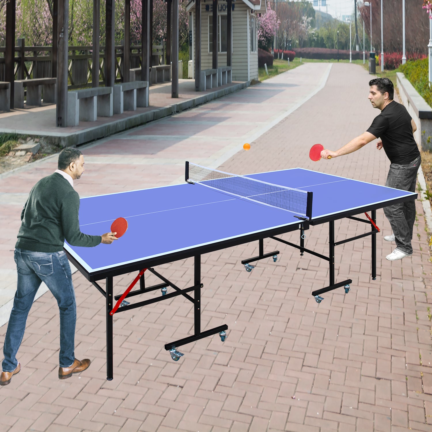 Foldable blue ping pong table with wheels two men playing tennis outdoors