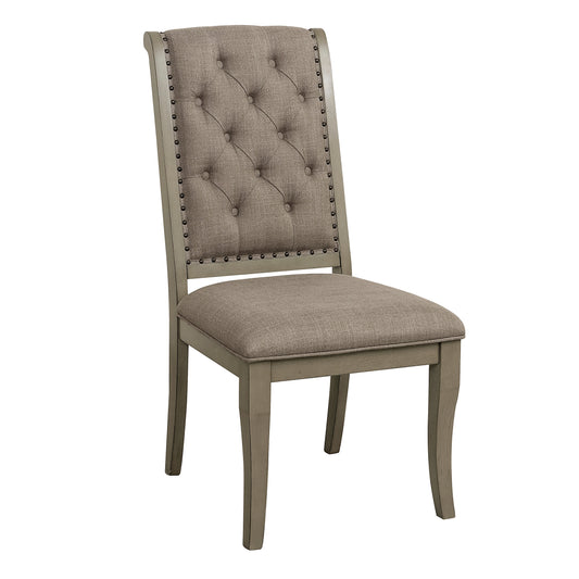 Tufted beige fabric dining chair with nailhead trim and carved wood legs