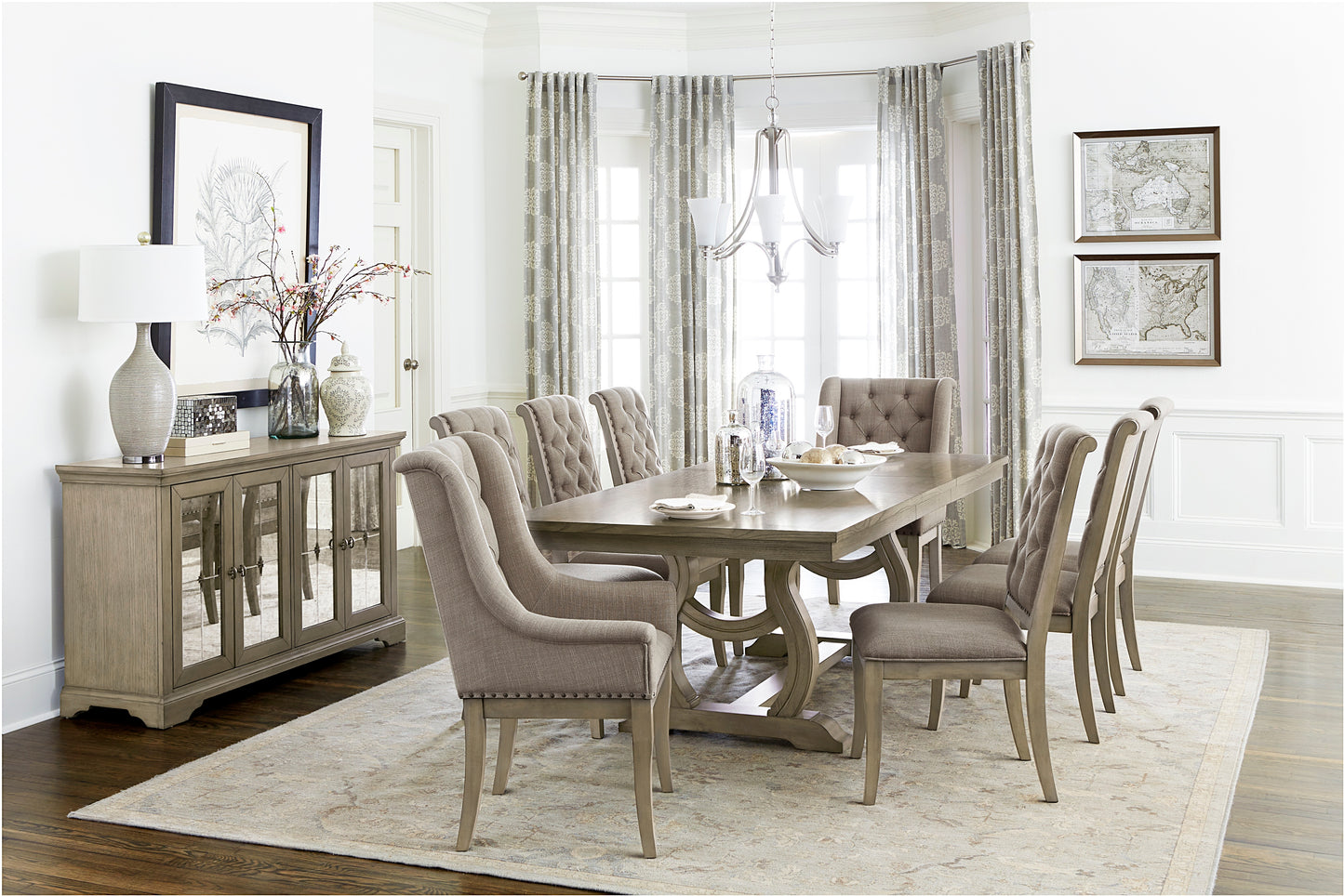 Tufted upholstered dining chairs in neutral taupe fabric surround a wooden dining table