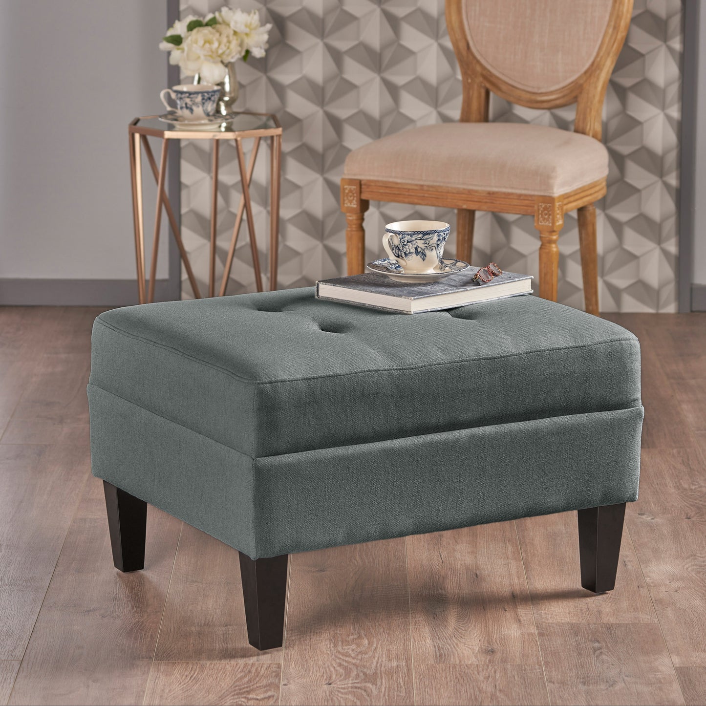 Tufted charcoal grey fabric ottoman with dark wooden legs and button details