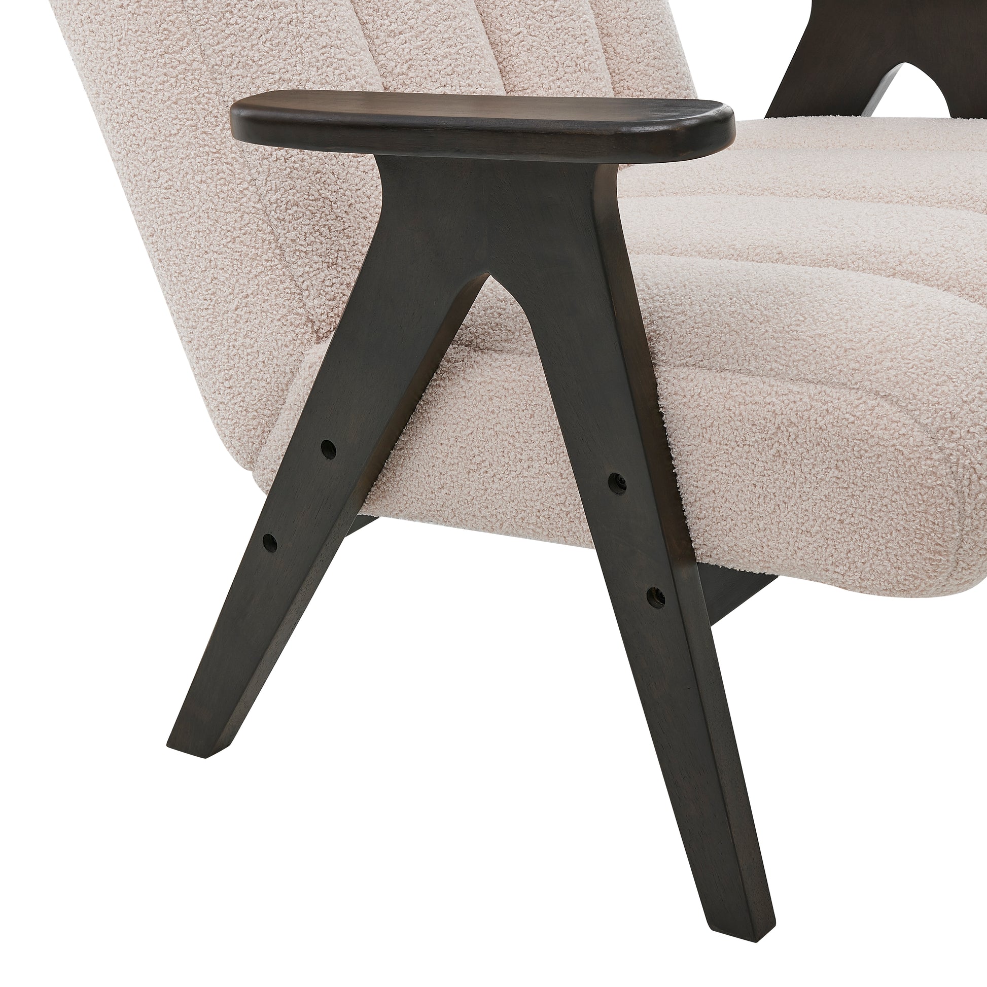 Closeup of boucle fabric armchair in cream with dark wood angled legs