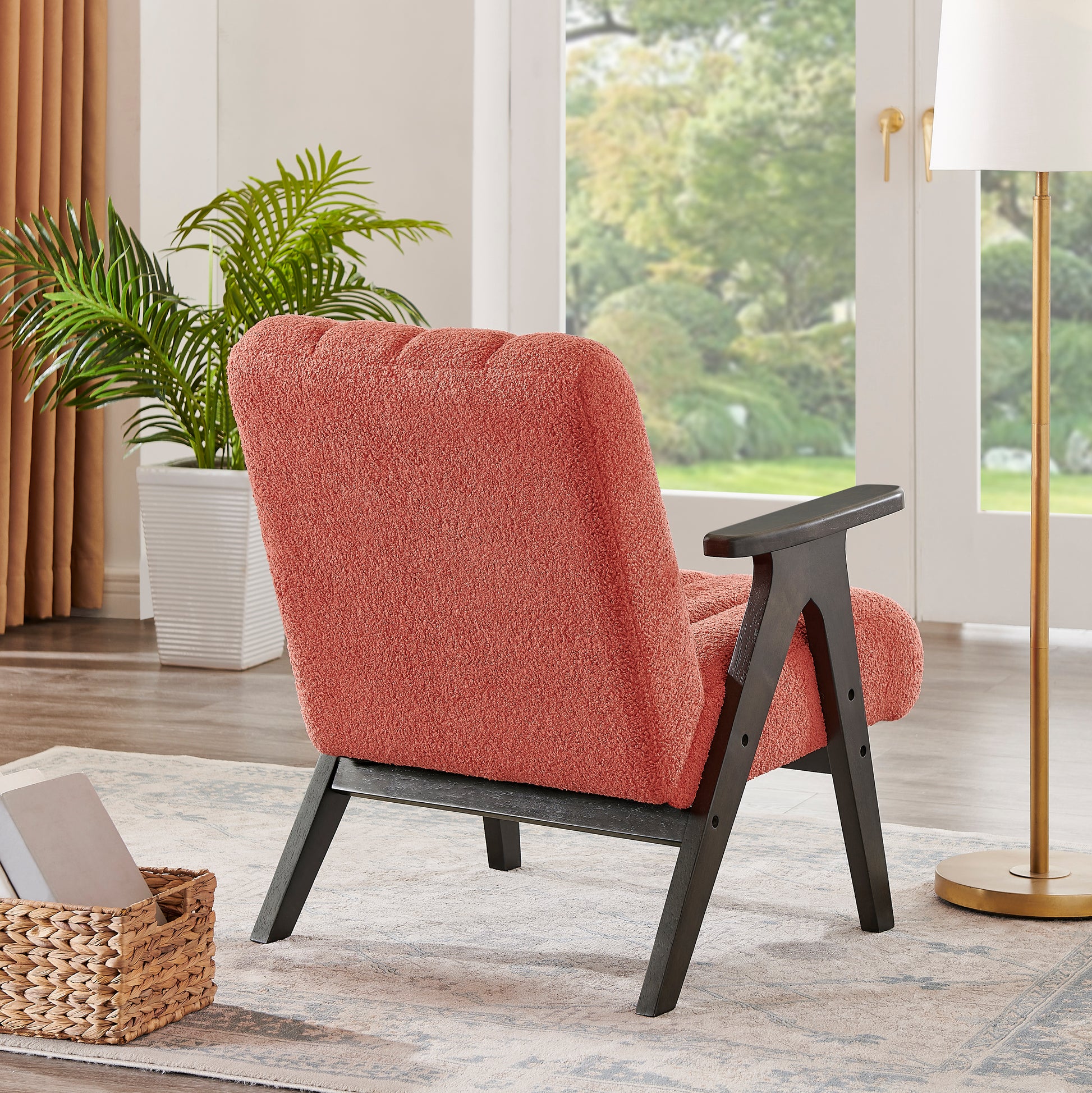 Coral boucle armchair with dark wood legs plush texture for cozy seating