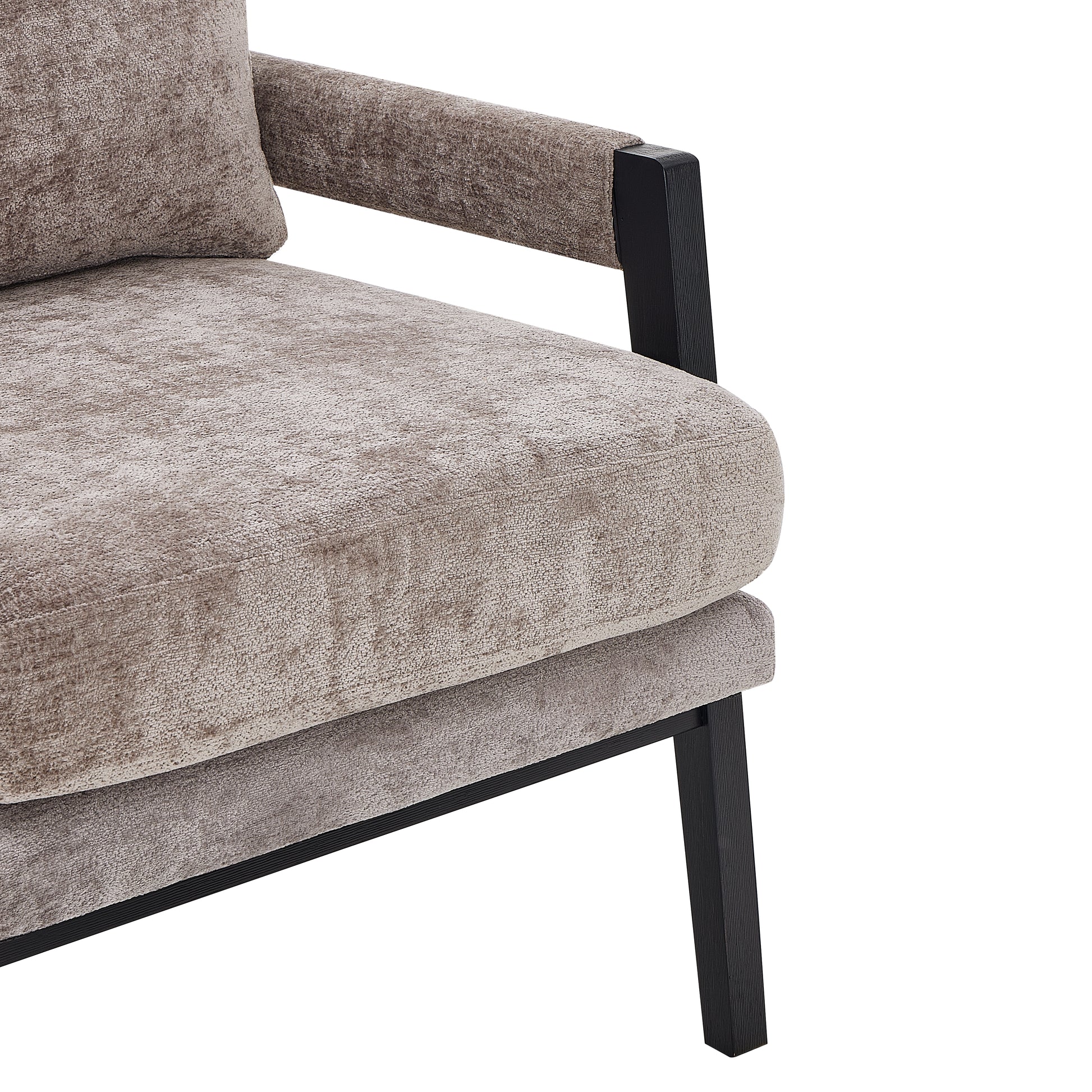 Closeup of a plush taupe velvet armchair with dark wood accents