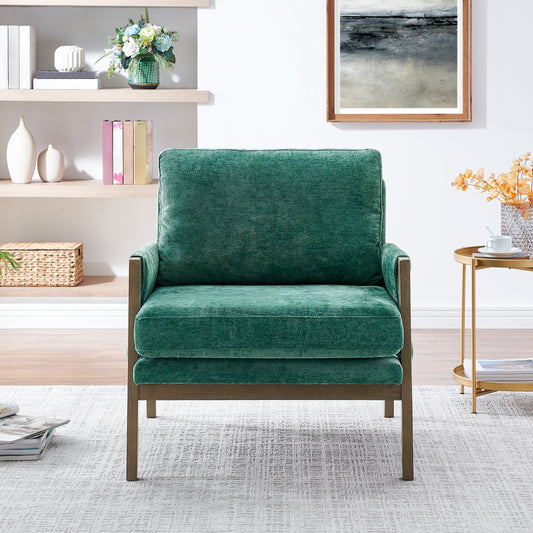 Plush emerald green velvet armchair with dark wood frame perfect for a cozy reading nook