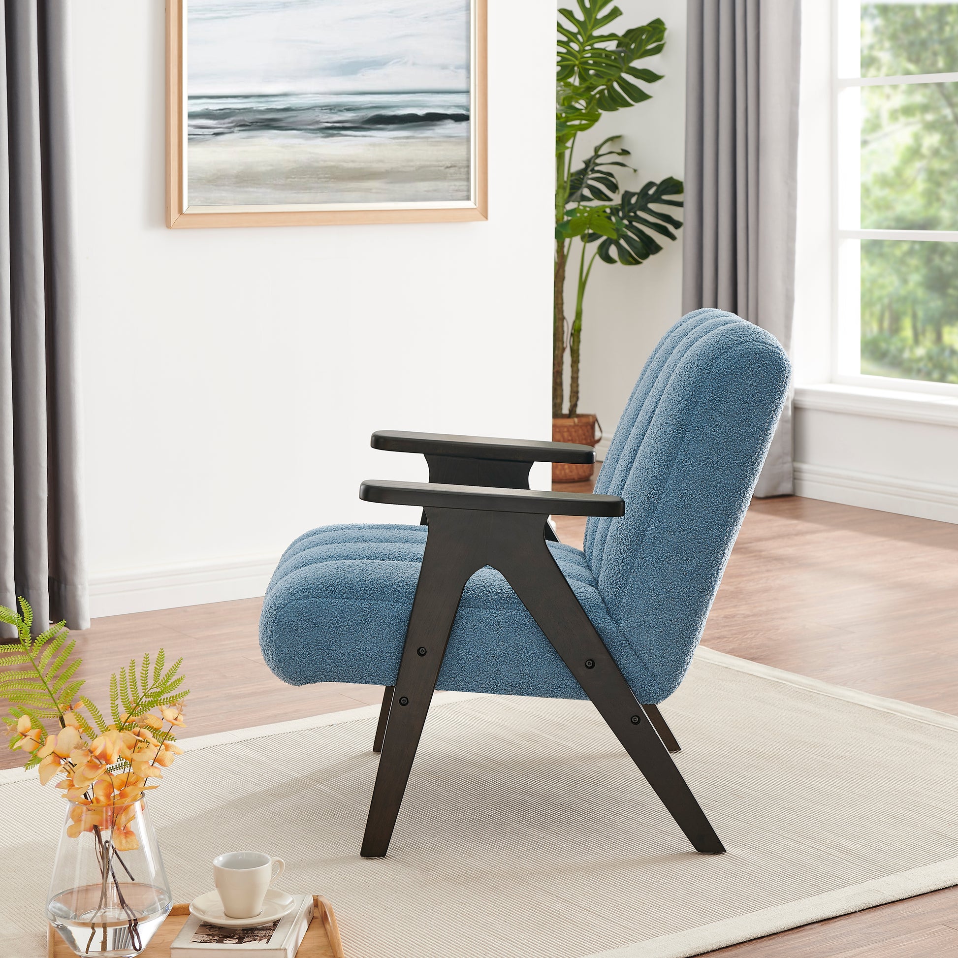 Cozy boucle fabric accent chair in a calming blue with dark wood legs and arms