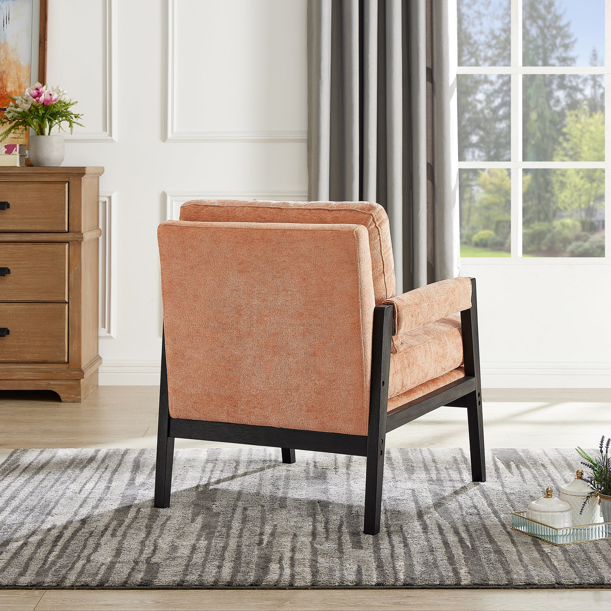 Terracotta textured accent chair with black wooden frame and arms