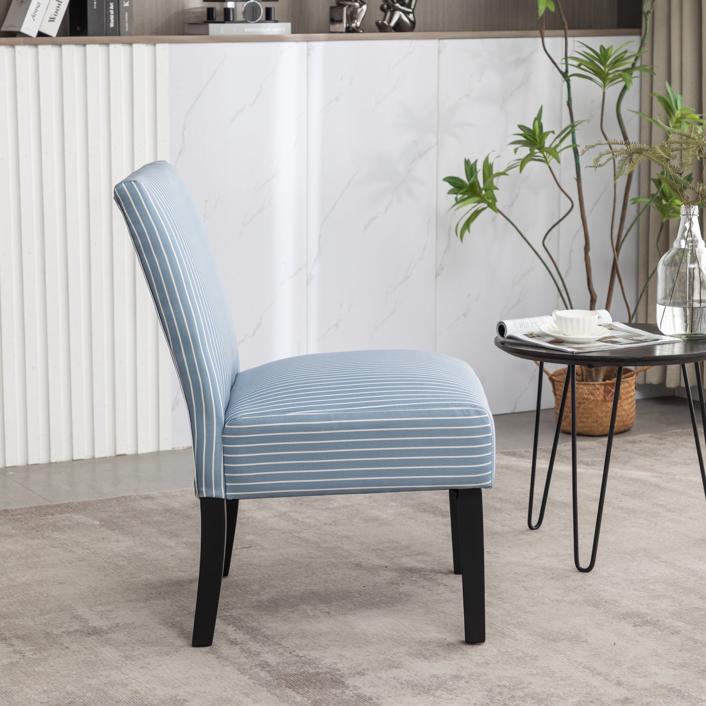 Blue and white striped accent chair with black legs perfect for small spaces