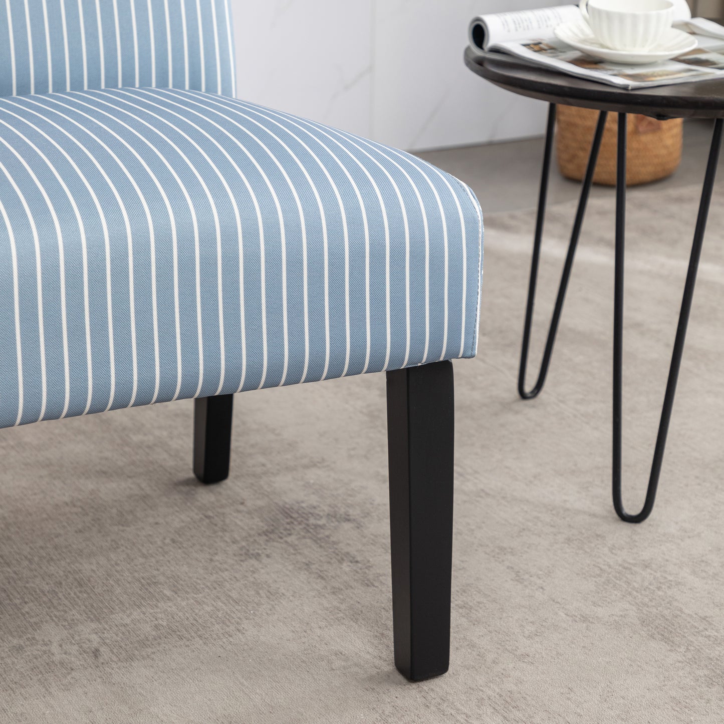 Blue and white striped armchair fabric with a black wooden leg