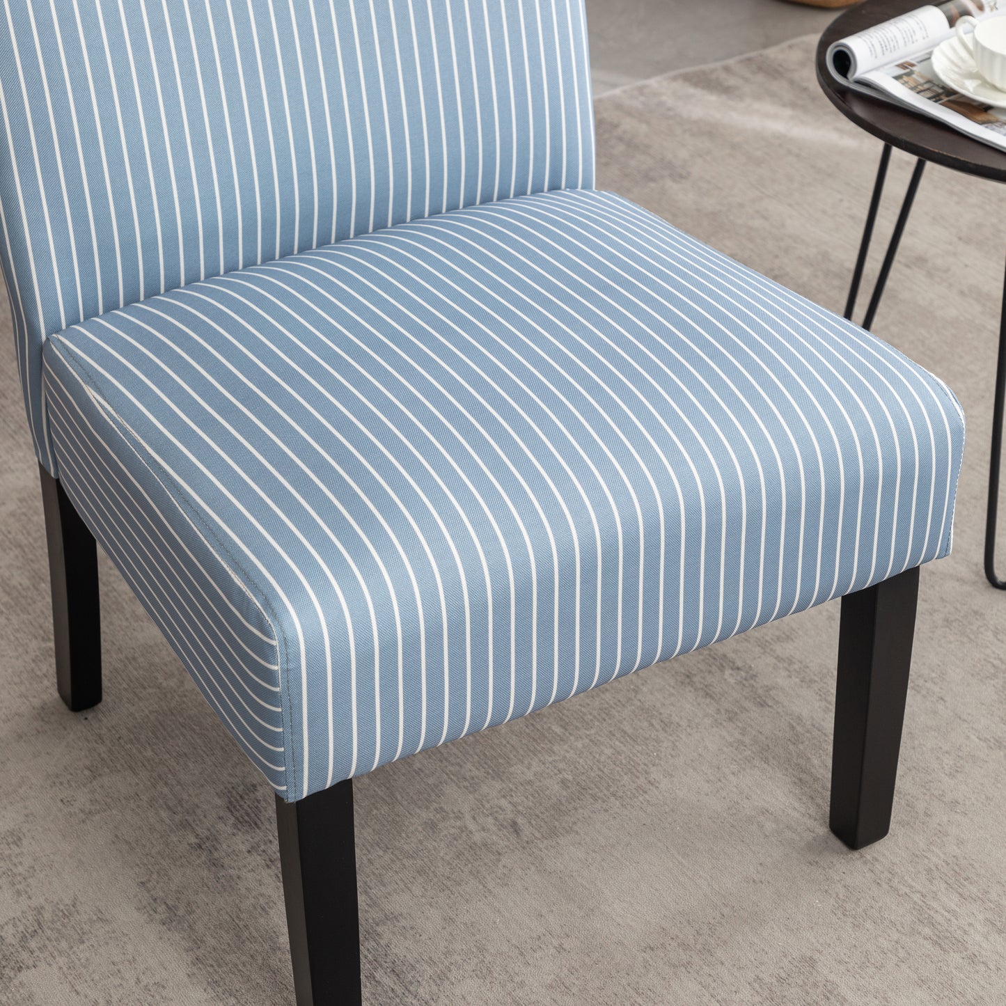 Blue and white striped accent chair with black legs perfect for living rooms