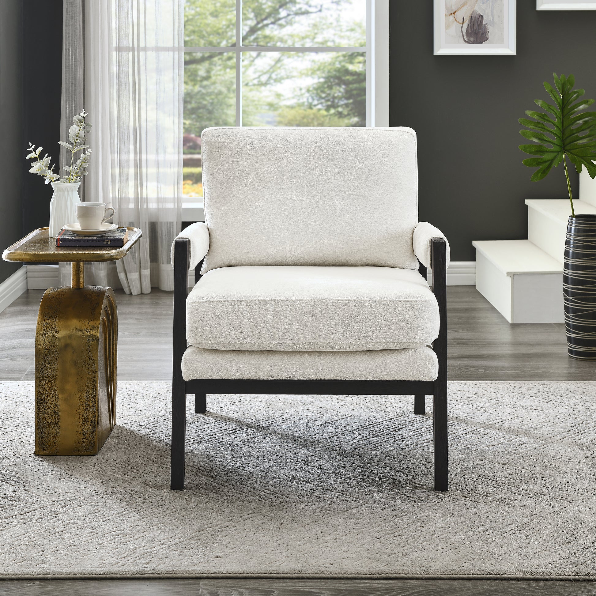Cream upholstered accent chair with black metal frame perfect for living rooms