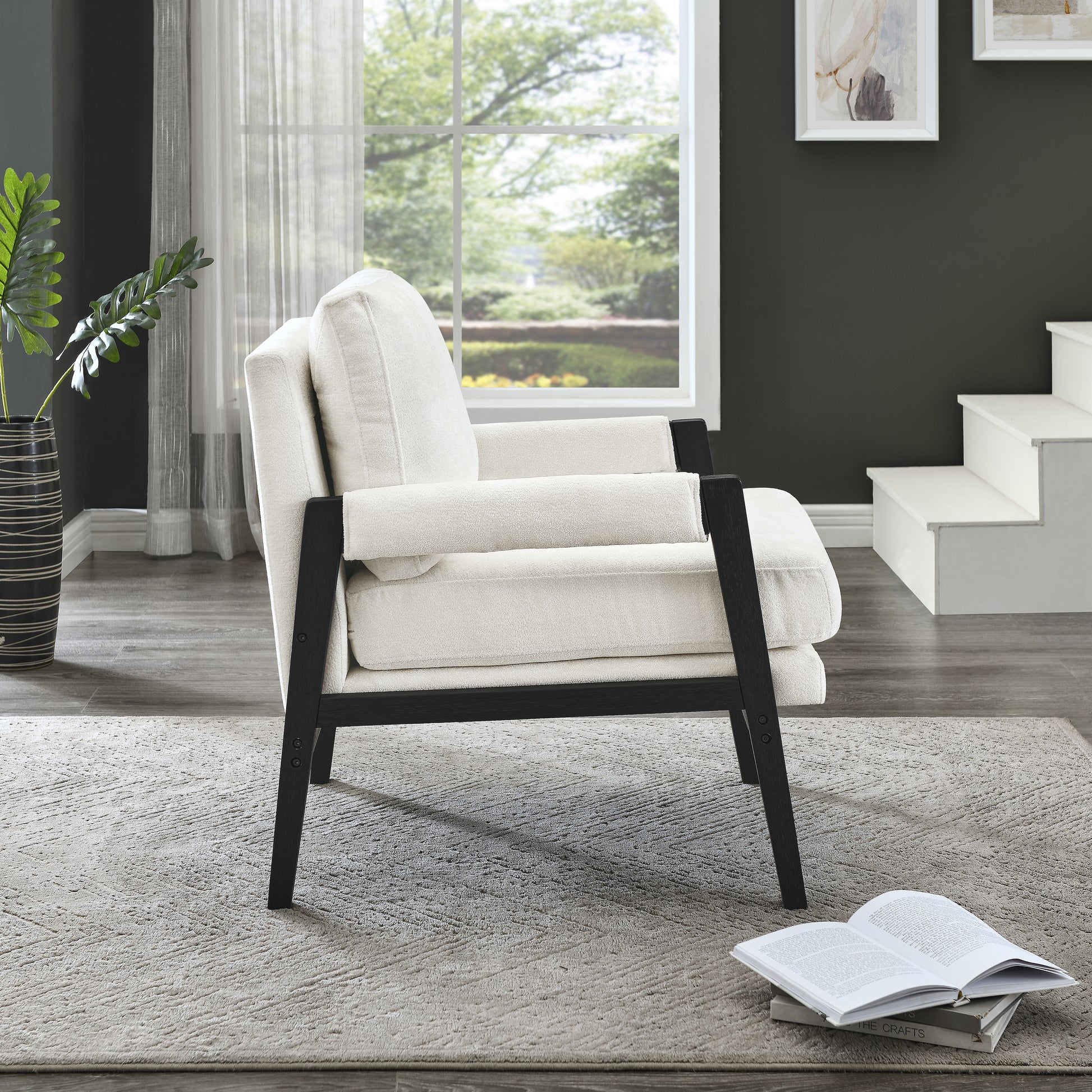 Cream boucle accent chair with dark wood frame on a textured rug