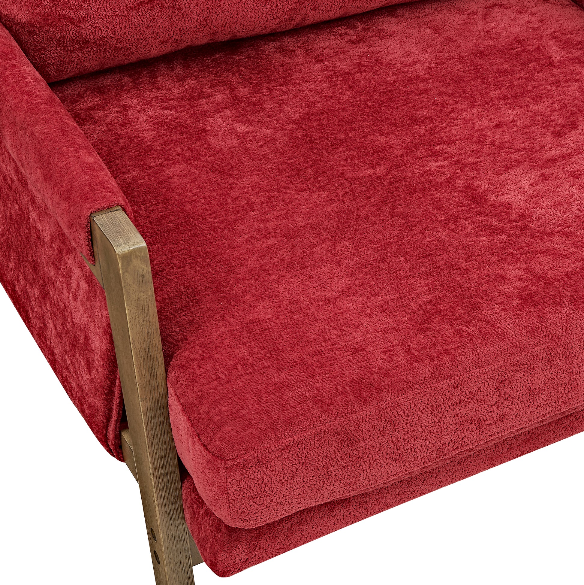 Plush red velvet armchair with rustic wooden armrest accent