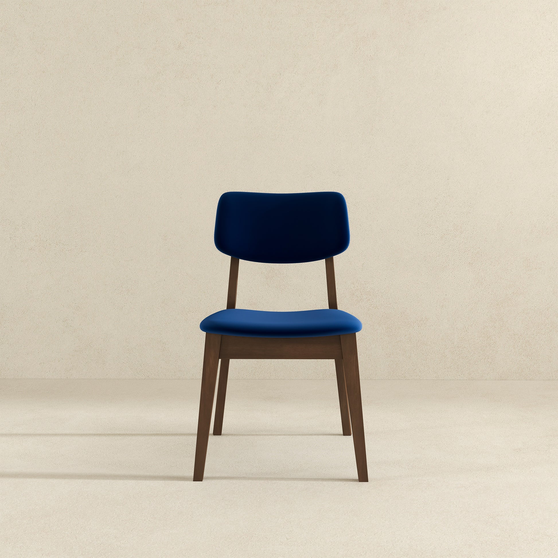 Deep blue velvet dining chair with a dark wood frame perfect for a modern kitchen
