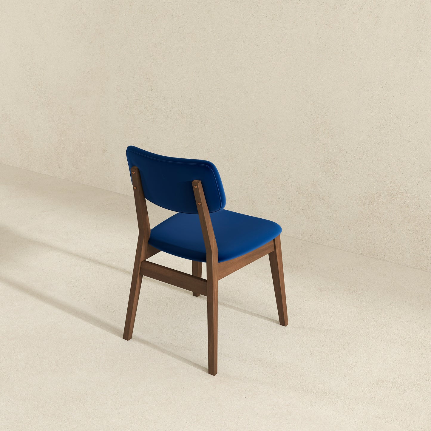 Elegant blue velvet dining chair with a rich walnut wood frame perfect for modern interiors