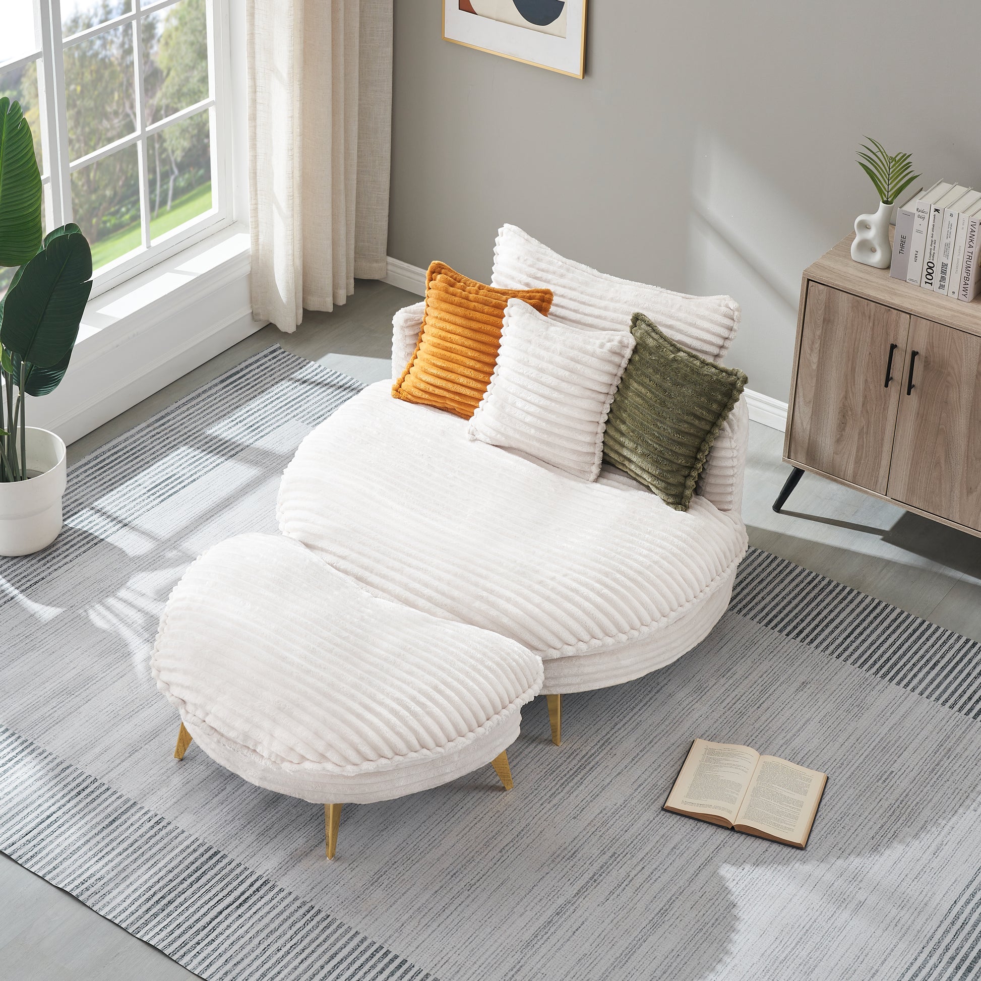Plush white corduroy sectional sofa with brass legs and colorful accent pillows