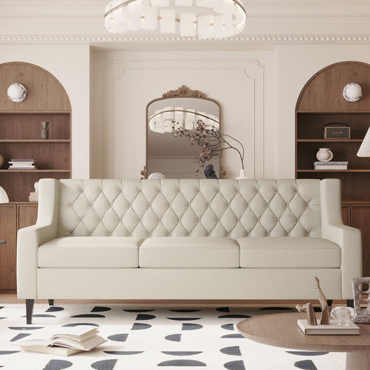 Tufted cream linen sofa with button accents and elegant winged arms perfect for a modern living room