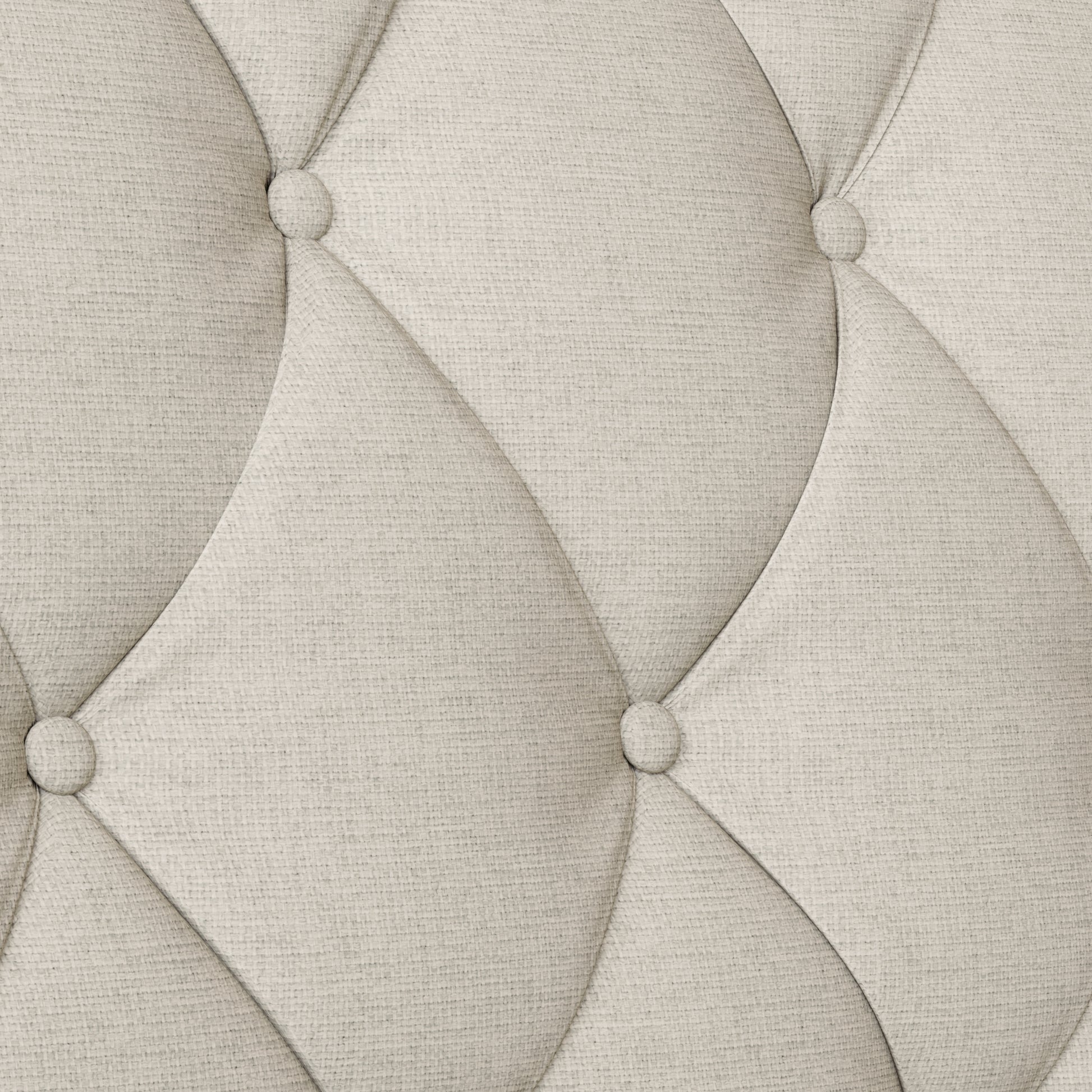 Closeup of light beige linen fabric with diamond tufting and button details